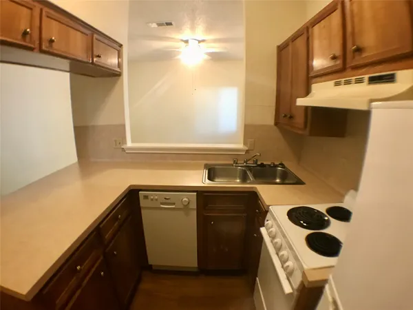 a kitchen with a sink a stove and a refrigerator
