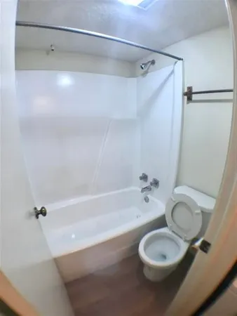 a bathroom with a granite countertop bathtub shower sink and vanity