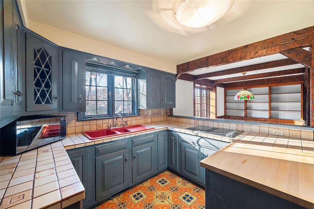 824 Flint Ridge Road Pittsburgh, PA 15243 - Photo 13 of 50 Every corner is optimized, including a secret access panel beneath the back staircase, cleverly hidden within the pantry.