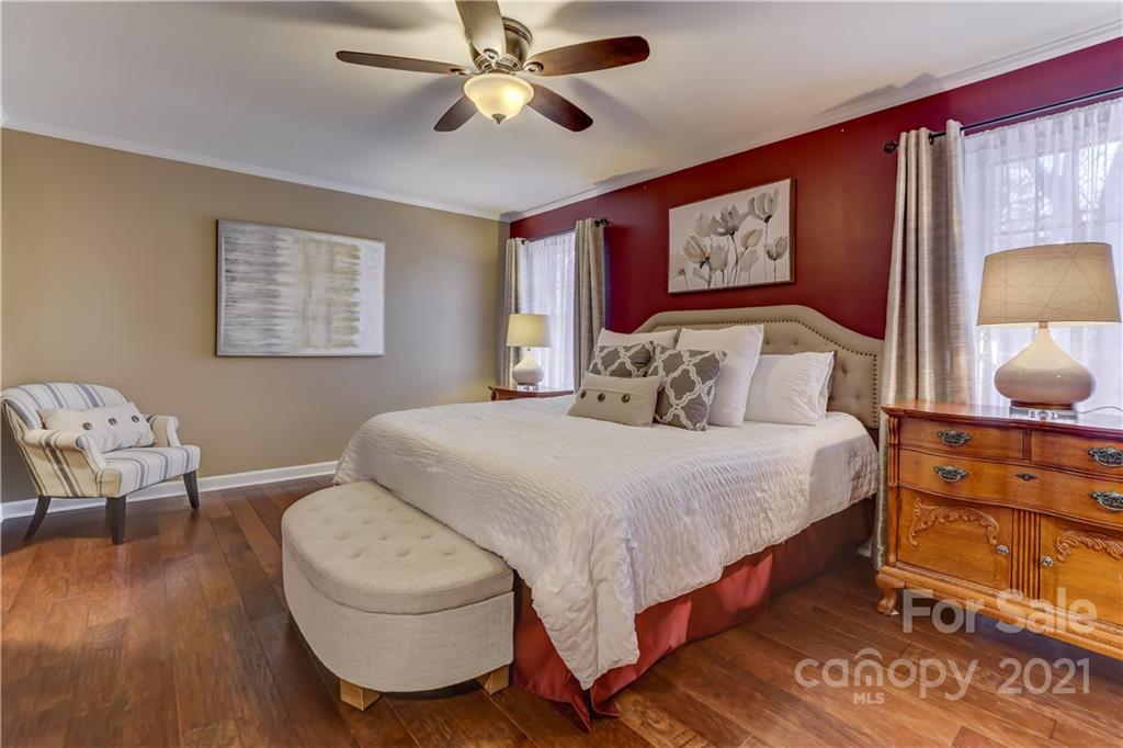 6601 Sharon Road Charlotte, NC 28210 - Photo 17 of 46 a bedroom with a bed and wooden floor