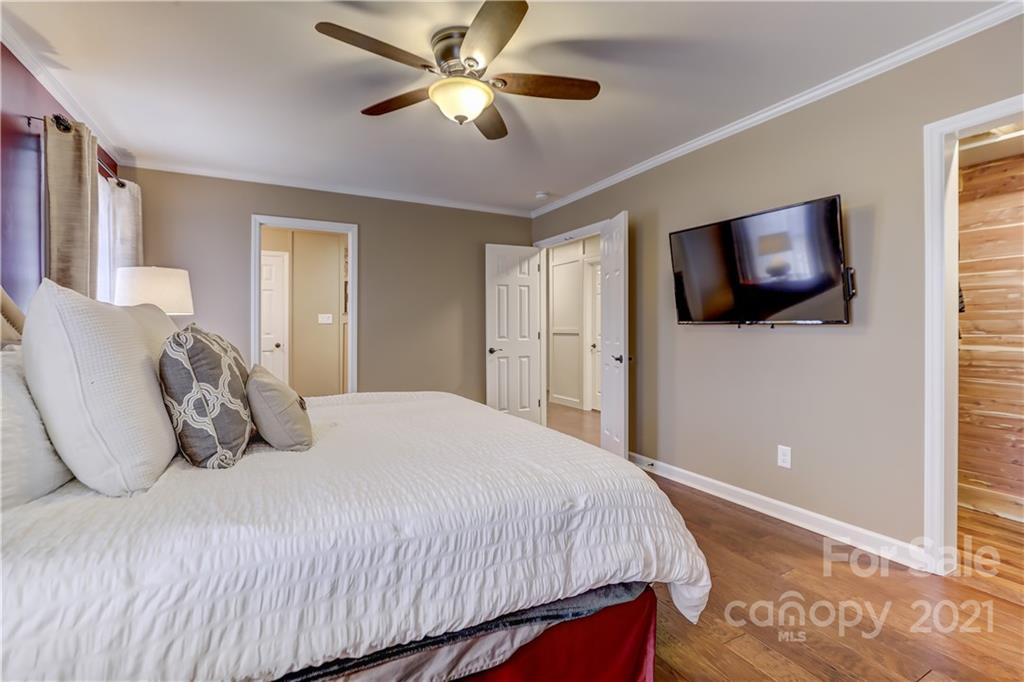 6601 Sharon Road Charlotte, NC 28210 - Photo 19 of 46 a bedroom with a large bed and a flat screen tv