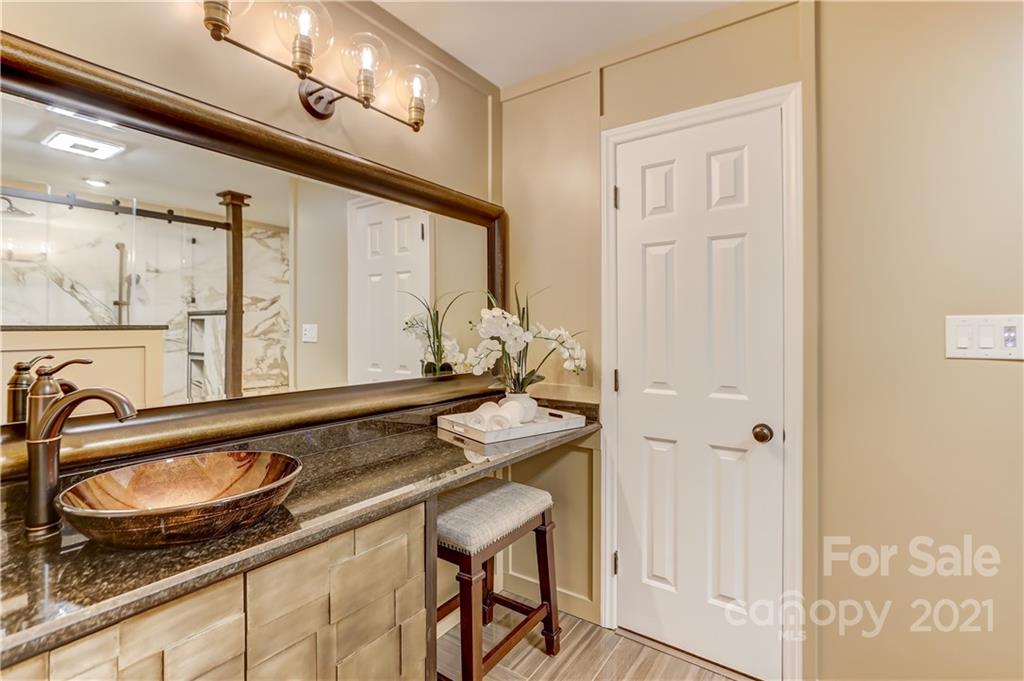 6601 Sharon Road Charlotte, NC 28210 - Photo 20 of 46 a bathroom with a sink and a mirror