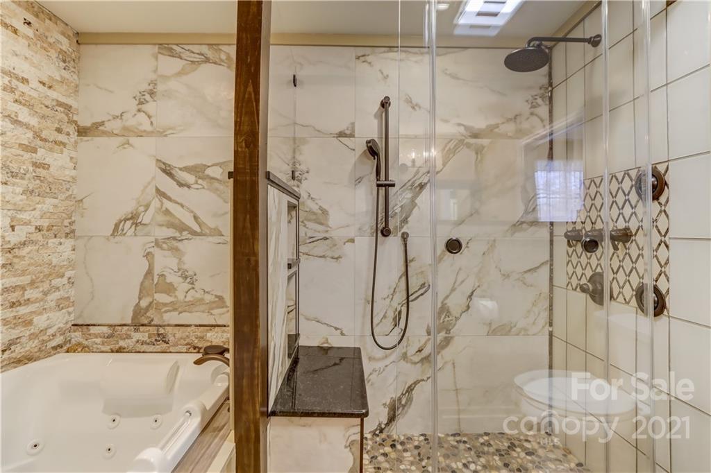 6601 Sharon Road Charlotte, NC 28210 - Photo 21 of 46 a bathroom with a bathtub and shower