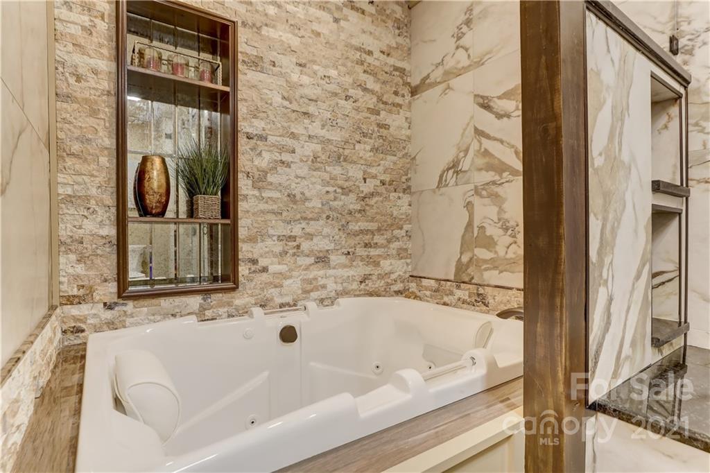 6601 Sharon Road Charlotte, NC 28210 - Photo 22 of 46 a bathroom with bathtub and a shower