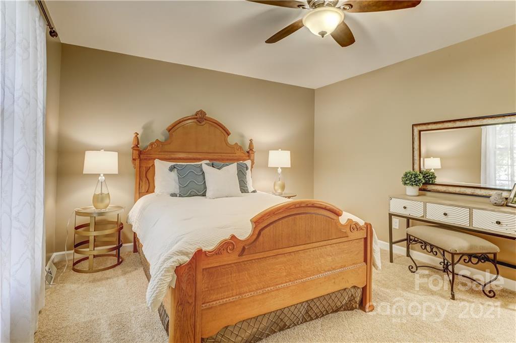 6601 Sharon Road Charlotte, NC 28210 - Photo 25 of 46 a bedroom with a bed and a chair