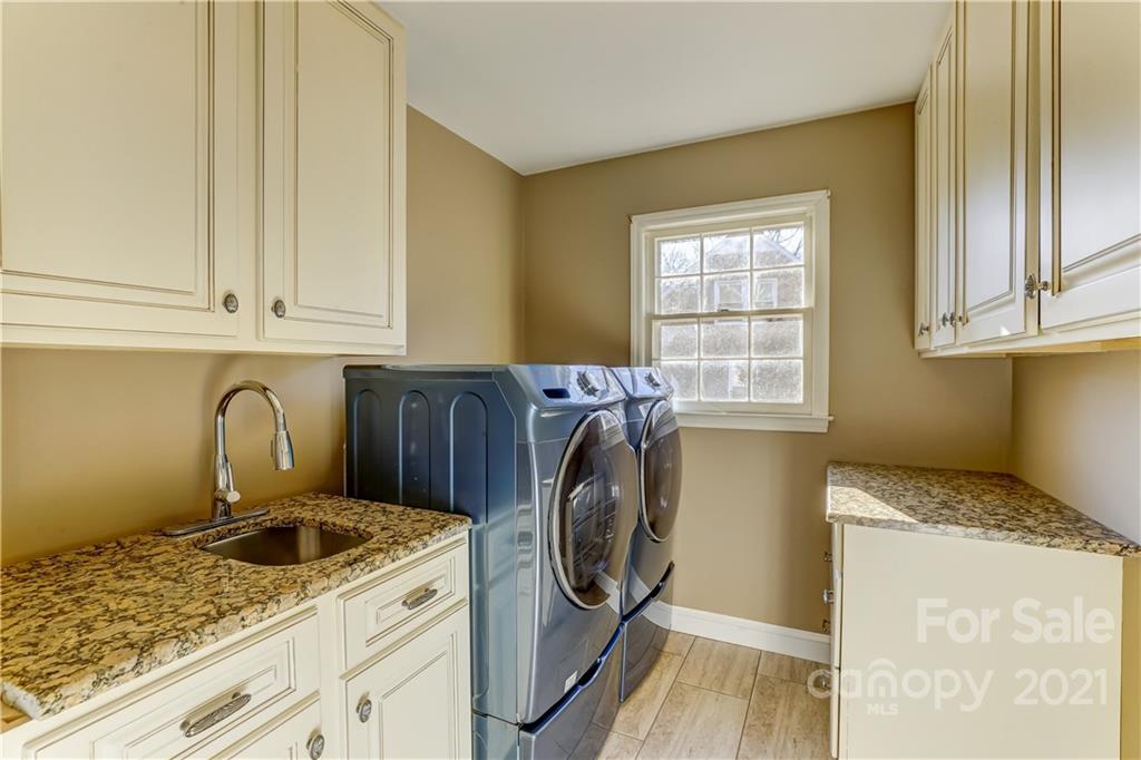 6601 Sharon Road Charlotte, NC 28210 - Photo 28 of 46 a utility room with a sink washer and dryer