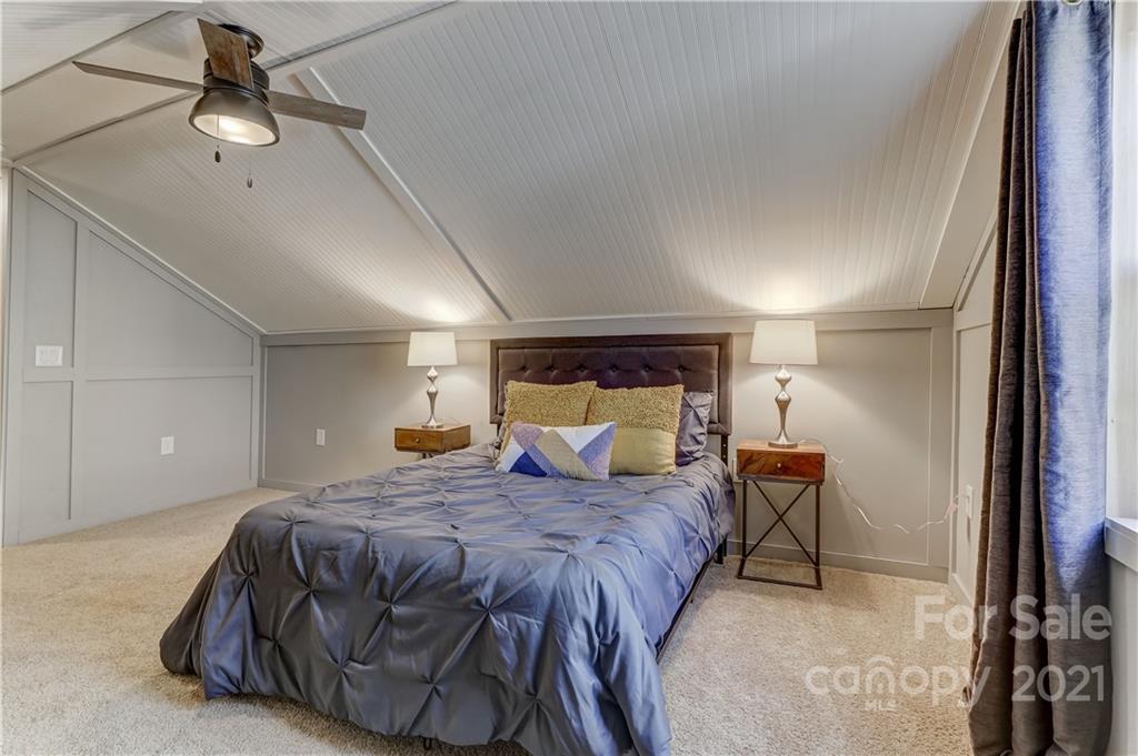 6601 Sharon Road Charlotte, NC 28210 - Photo 33 of 46 a bedroom with a bed and a chandelier