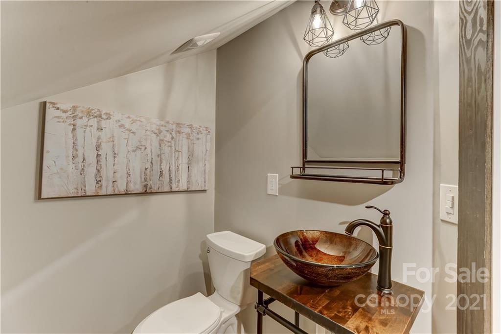6601 Sharon Road Charlotte, NC 28210 - Photo 36 of 46 a bathroom with a toilet and a mirror