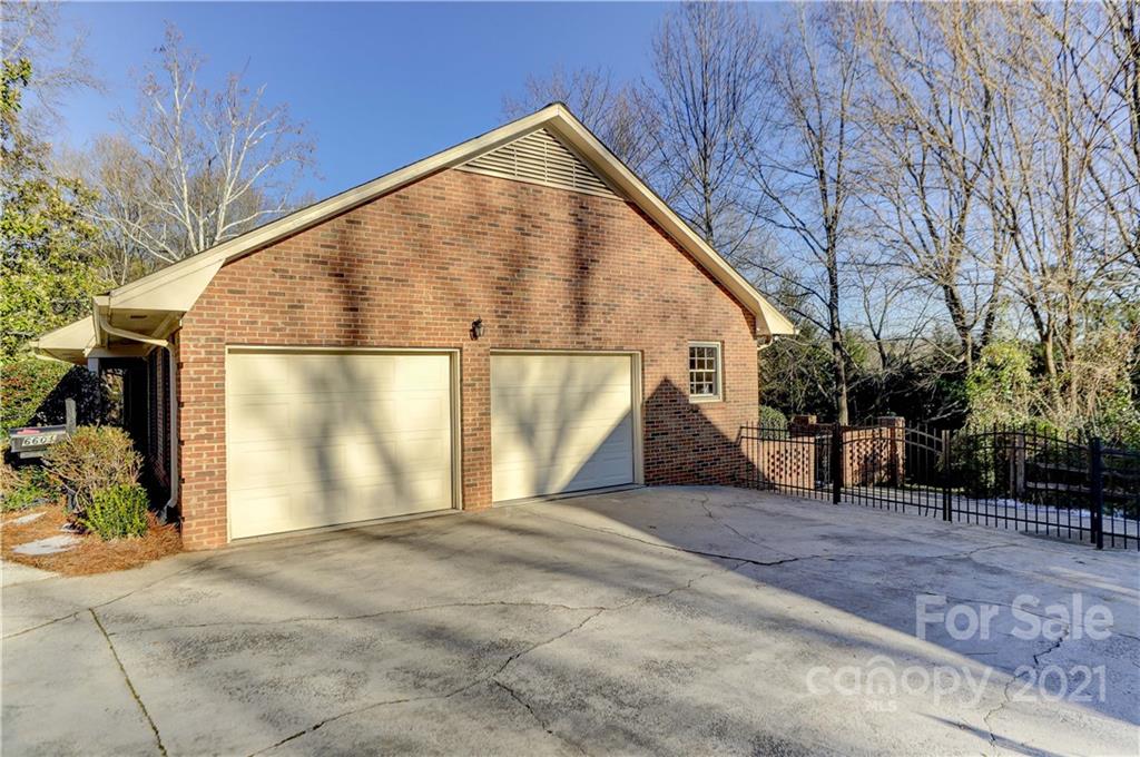 6601 Sharon Road Charlotte, NC 28210 - Photo 37 of 46 a view of a house with a backyard