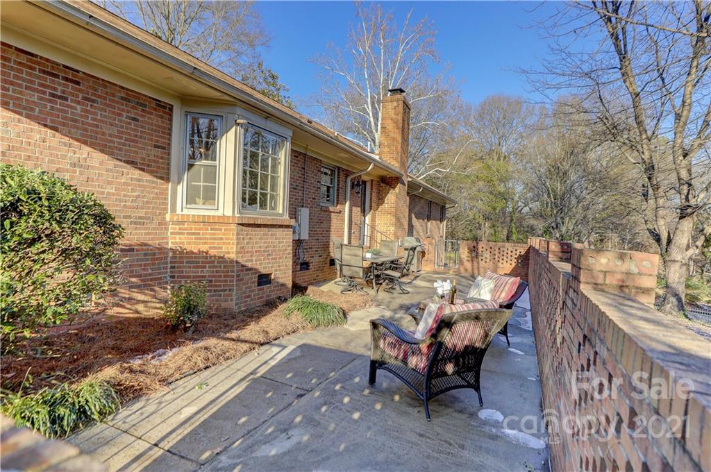 6601 Sharon Road Charlotte, NC 28210 - Photo 41 of 46 a view of a patio with table and chairs and wooden fence