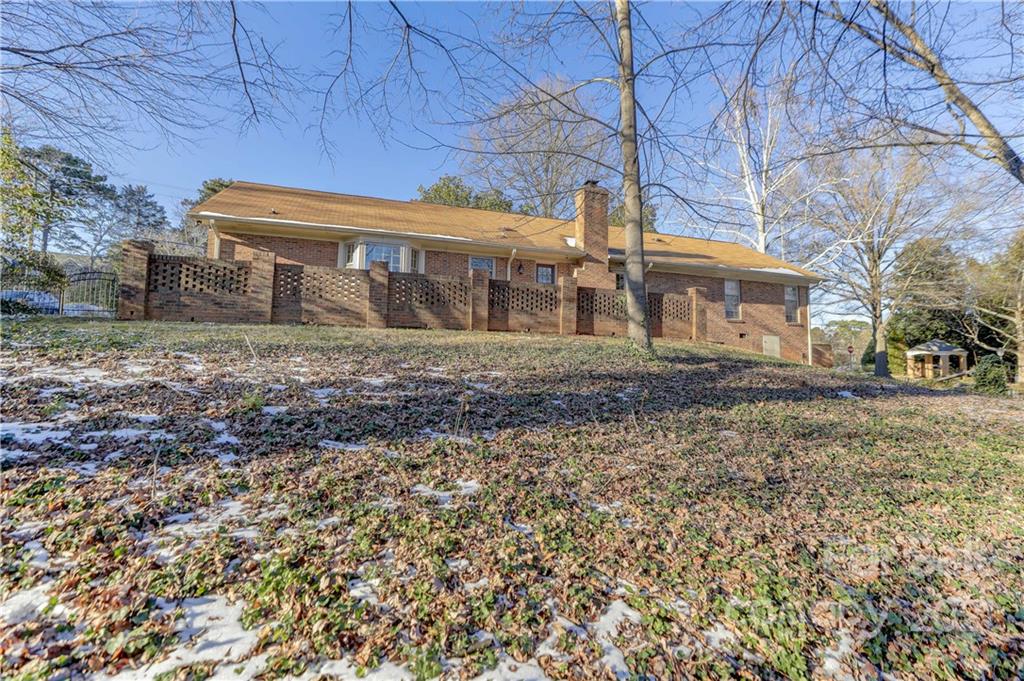 6601 Sharon Road Charlotte, NC 28210 - Photo 44 of 46 a front view of a house with a yard