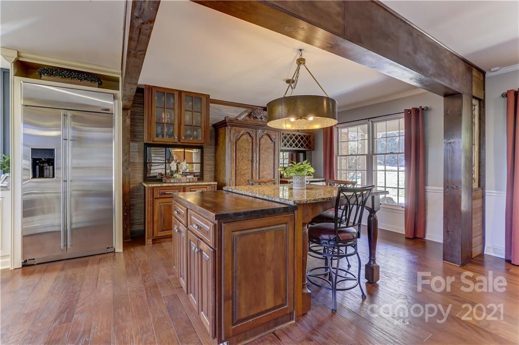6601 Sharon Road Charlotte, NC 28210 - Photo 6 of 46 a kitchen with stainless steel appliances granite countertop a stove and refrigerator