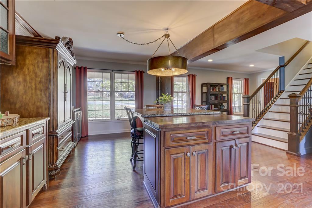 6601 Sharon Road Charlotte, NC 28210 - Photo 7 of 46 a kitchen with stainless steel appliances granite countertop a stove and a wooden floors