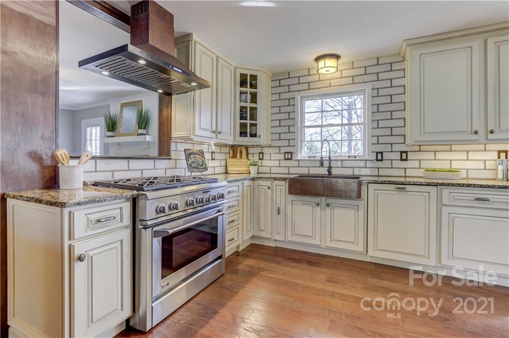 6601 Sharon Road Charlotte, NC 28210 - Photo 8 of 46 a kitchen with granite countertop a sink stainless steel appliances and cabinets