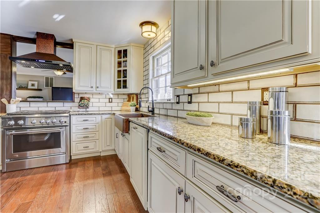 6601 Sharon Road Charlotte, NC 28210 - Photo 9 of 46 a kitchen with stainless steel appliances granite countertop a stove a sink and a microwave