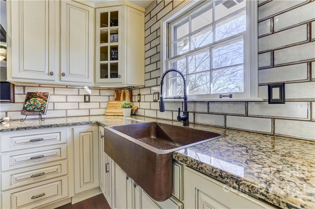 6601 Sharon Road Charlotte, NC 28210 - Photo 10 of 46 a kitchen that has a sink and a stove