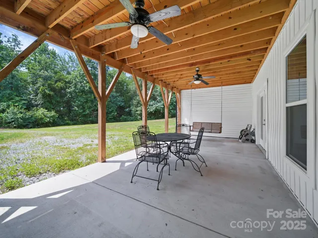 a patio with yard glass top table and chairs