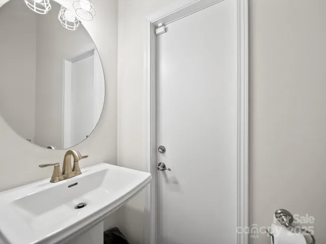 a bathroom with a sink mirror and vanity