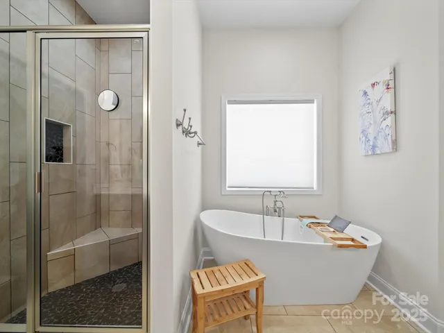 a bathroom with a tub and shower