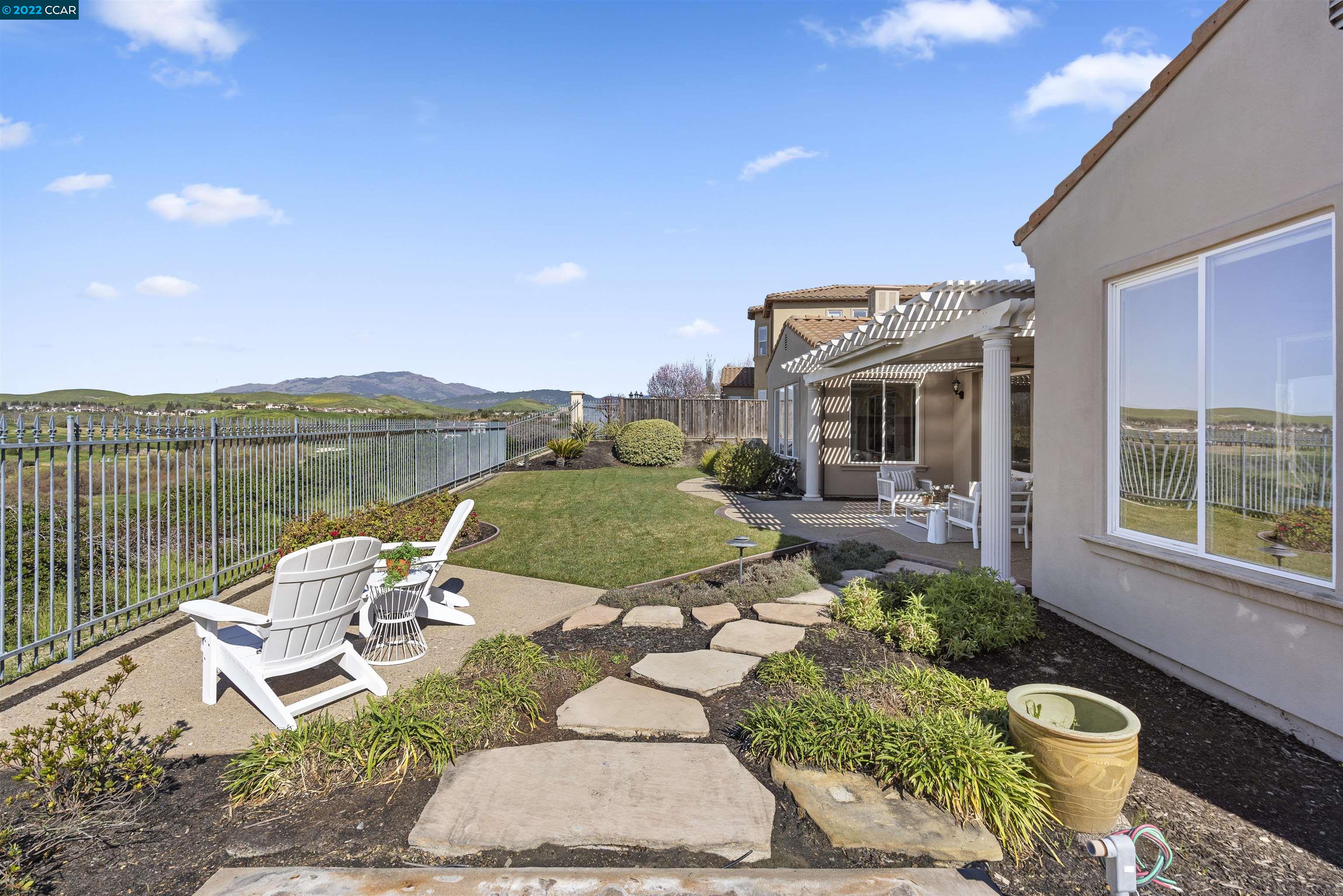 9548 Velvetleaf Circle San Ramon, CA 94582 - Photo 3 of 13 a view of a patio with couches table and chairs under an umbrella