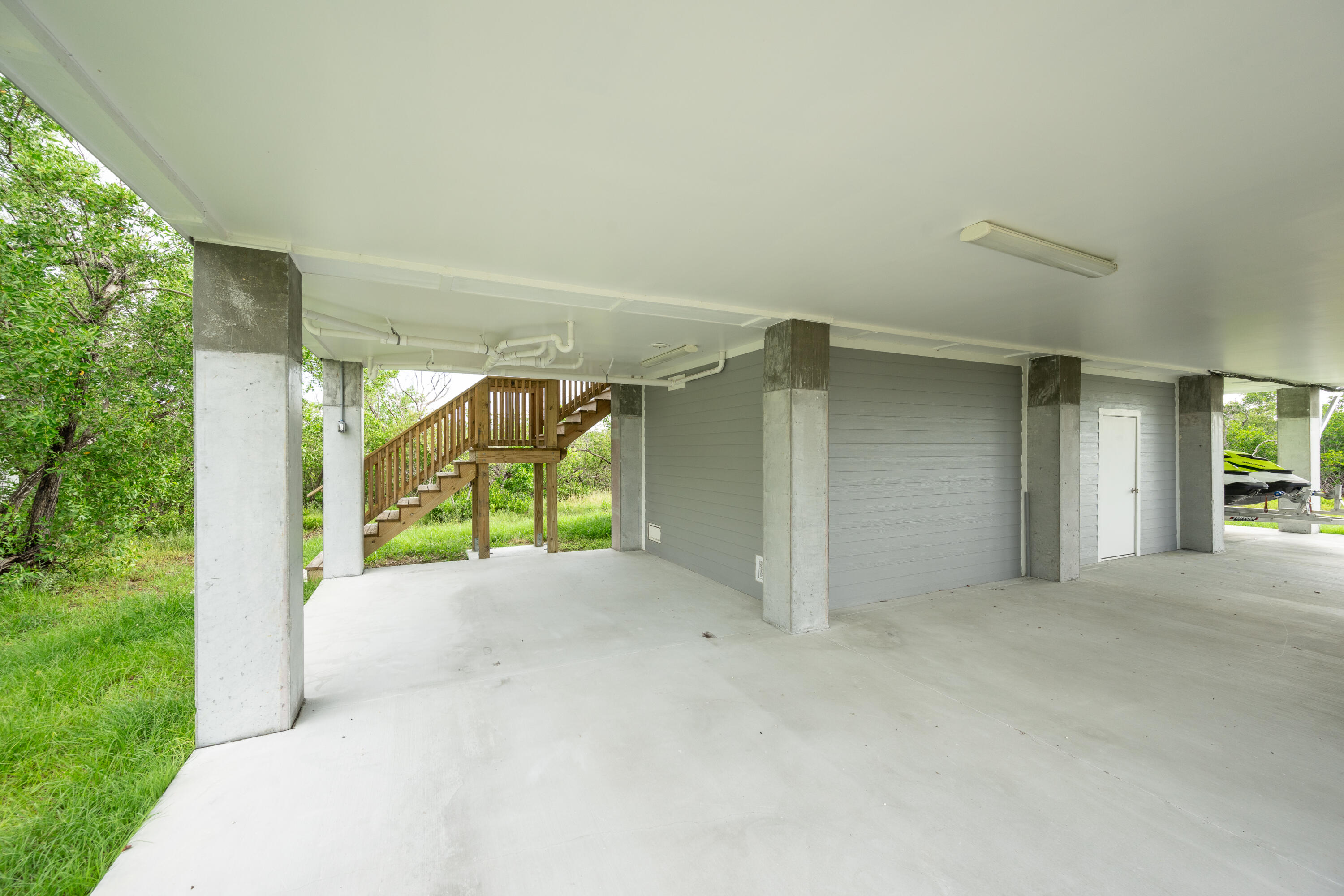 26868 Mariposa Road Summerland Key, FL 33042 - Photo 21 of 30 a view of an empty room with a sliding door and windows