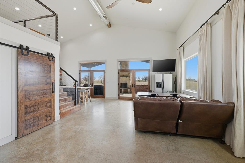 140 Turkey Farm Road Whitesboro, TX 76273 - Photo 12 of 38 a living room with furniture a fireplace and a flat screen tv