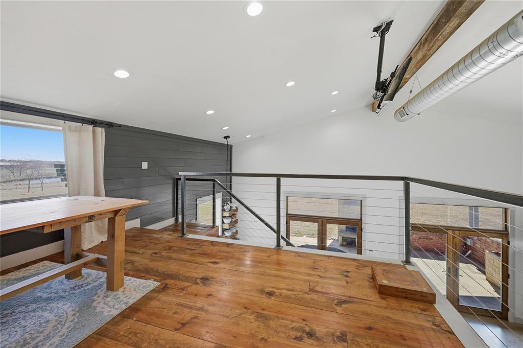 140 Turkey Farm Road Whitesboro, TX 76273 - Photo 17 of 38 a room with wooden floor and windows