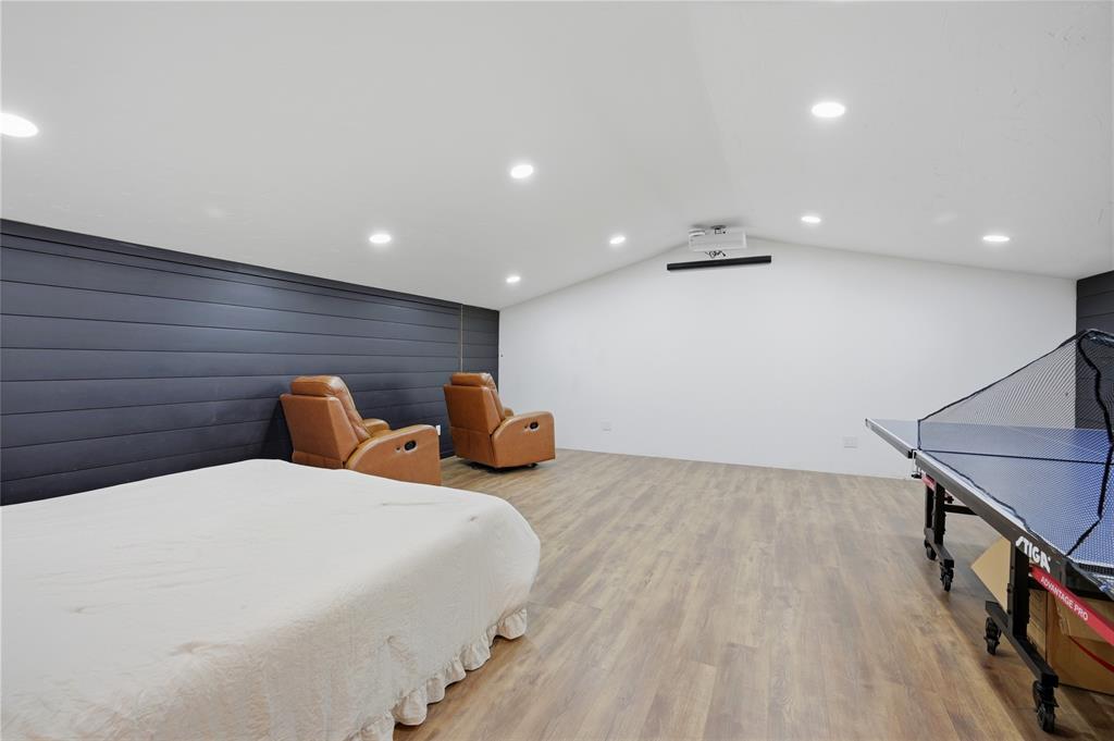 140 Turkey Farm Road Whitesboro, TX 76273 - Photo 20 of 38 a bedroom with a bed and a chandelier