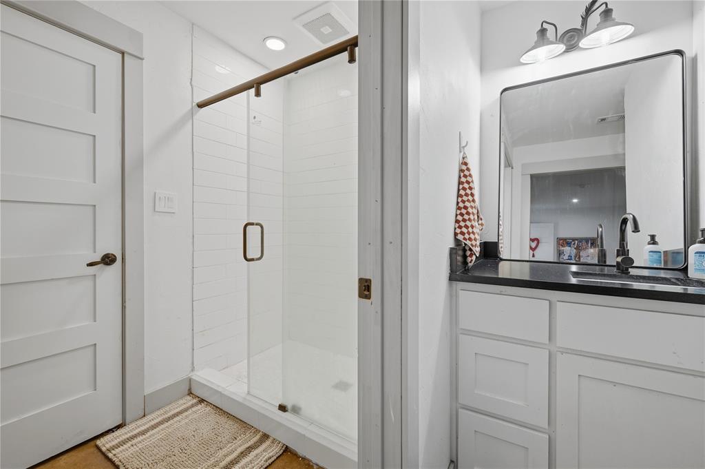 140 Turkey Farm Road Whitesboro, TX 76273 - Photo 26 of 38 a bathroom with a shower sink and mirror
