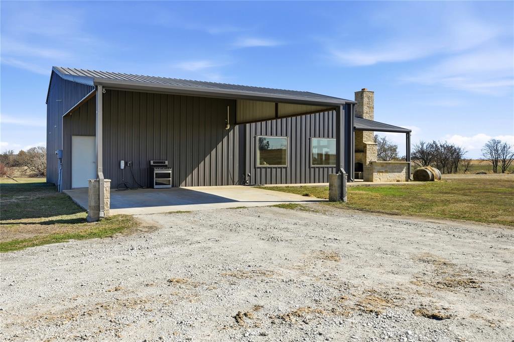 140 Turkey Farm Road Whitesboro, TX 76273 - Photo 5 of 38 a view of a house with backyard and trees