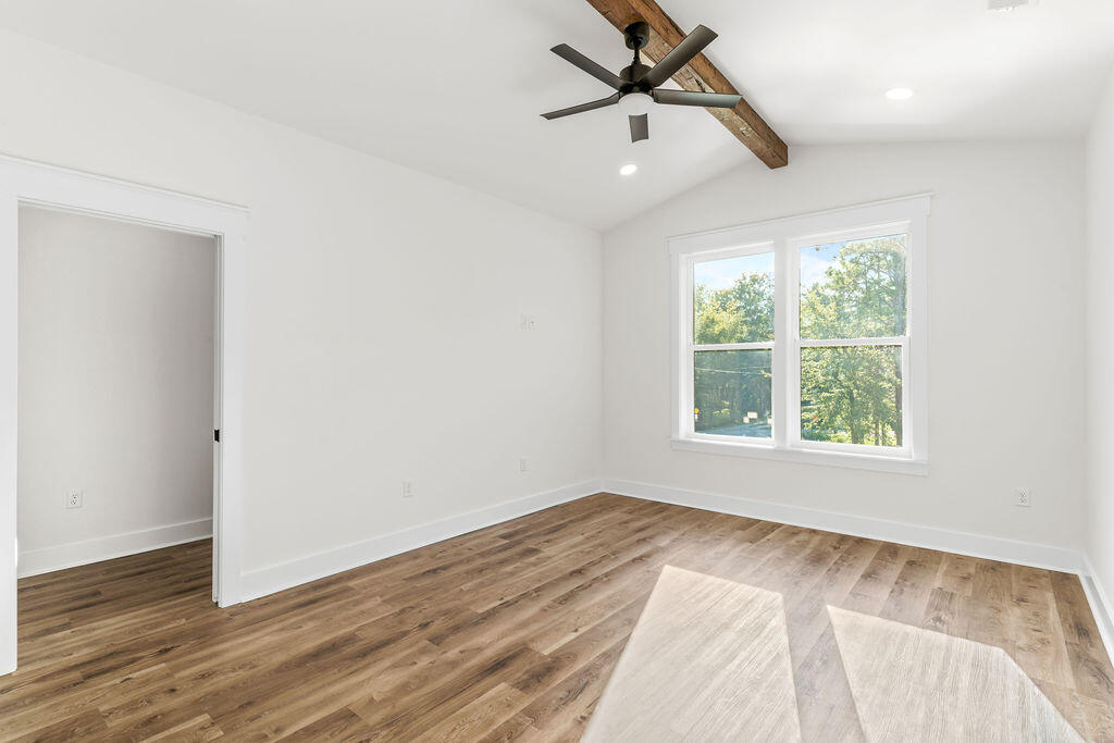 32 22nd Street Santa Rosa Beach, FL 32459 - Photo 12 of 26 an empty room with wooden floor fan and windows