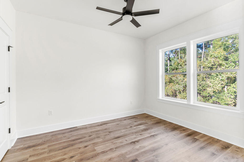 32 22nd Street Santa Rosa Beach, FL 32459 - Photo 16 of 26 a view of a room with wooden floor and windows