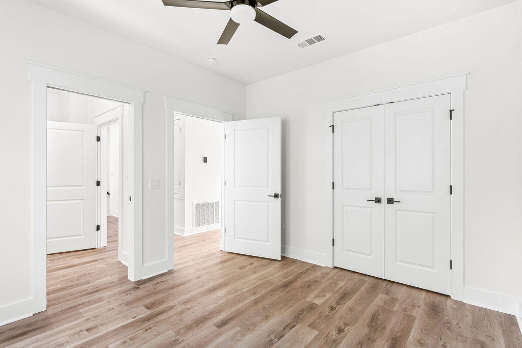 32 22nd Street Santa Rosa Beach, FL 32459 - Photo 17 of 26 a view of a livingroom with wooden floor and a ceiling fan