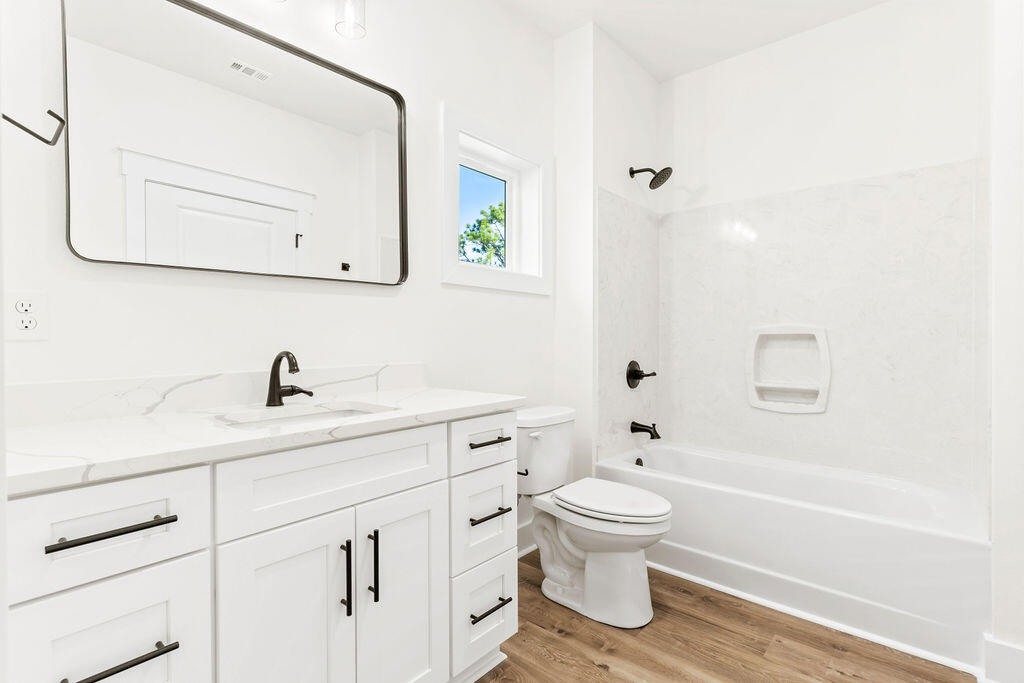32 22nd Street Santa Rosa Beach, FL 32459 - Photo 18 of 26 a bathroom with a toilet sink a mirror and vanity
