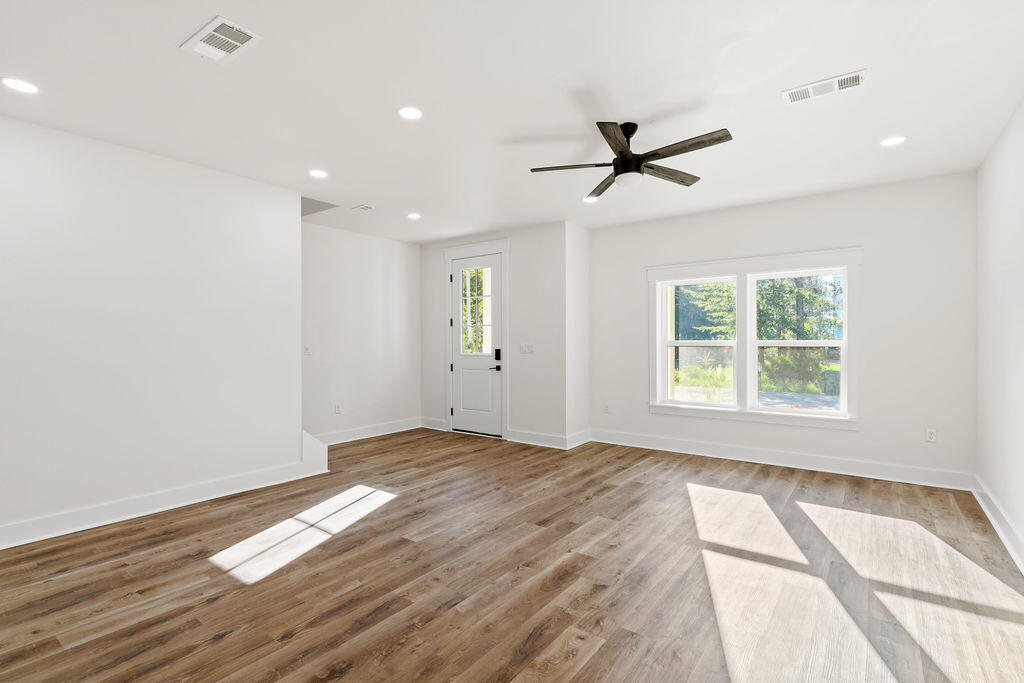 32 22nd Street Santa Rosa Beach, FL 32459 - Photo 4 of 26 a view of empty room with wooden floor and fan
