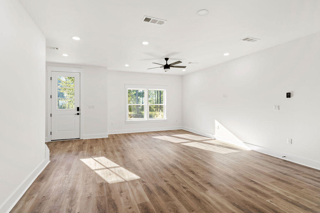 32 22nd Street Santa Rosa Beach, FL 32459 - Photo 5 of 26 an empty room with wooden floor and windows
