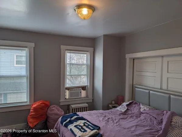 a bedroom with furniture and a flat screen tv
