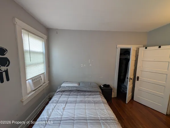 a bedroom with a bed and a television