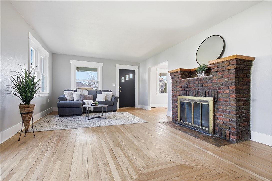 1925 Sunset Avenue Springfield, OH 45505 - Photo 8 of 45 This living room features gleaming hardwood floors and a brick fireplace, creating a warm and inviting atmosphere.