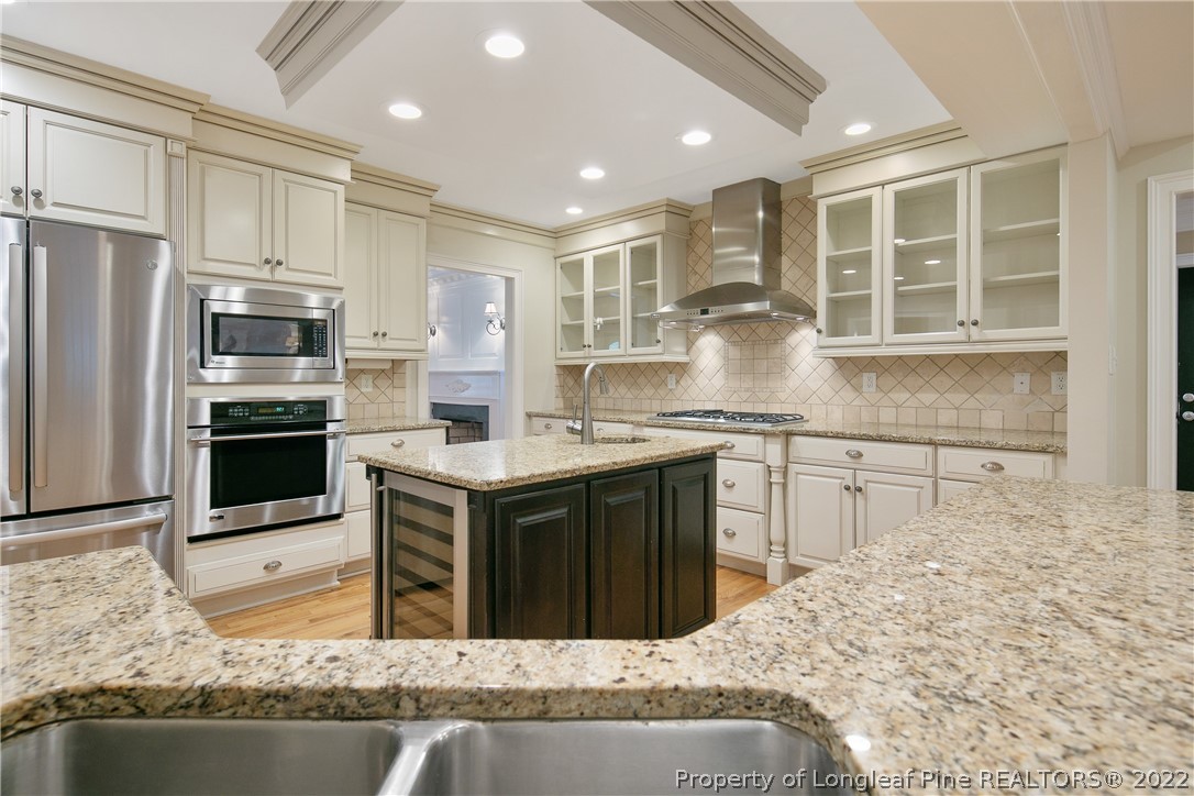 501 Rush Road Fayetteville, NC 28305 - Photo 11 of 50 a kitchen with kitchen island granite countertop a stove sink and refrigerator