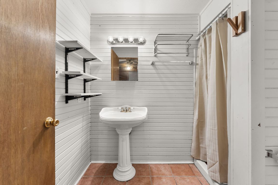 5413 Duval Street Austin, TX 78751 - Photo 12 of 27 a bathroom with a sink and mirror