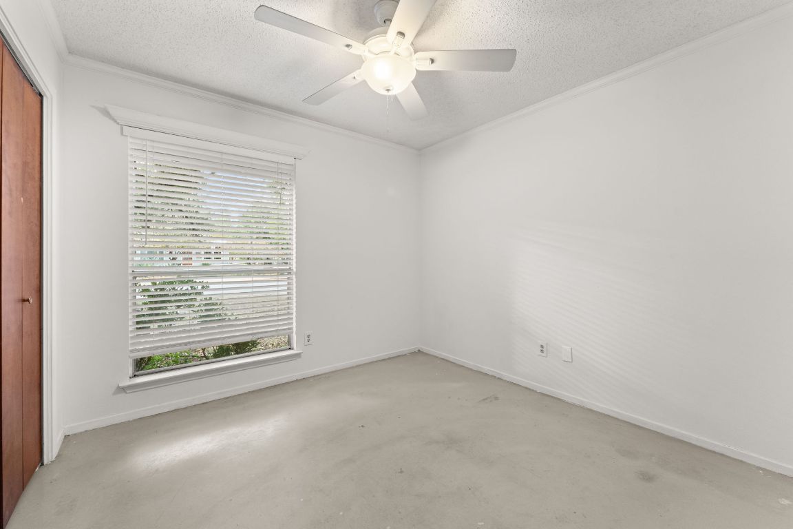 5413 Duval Street Austin, TX 78751 - Photo 14 of 27 an empty room with a window and a fan