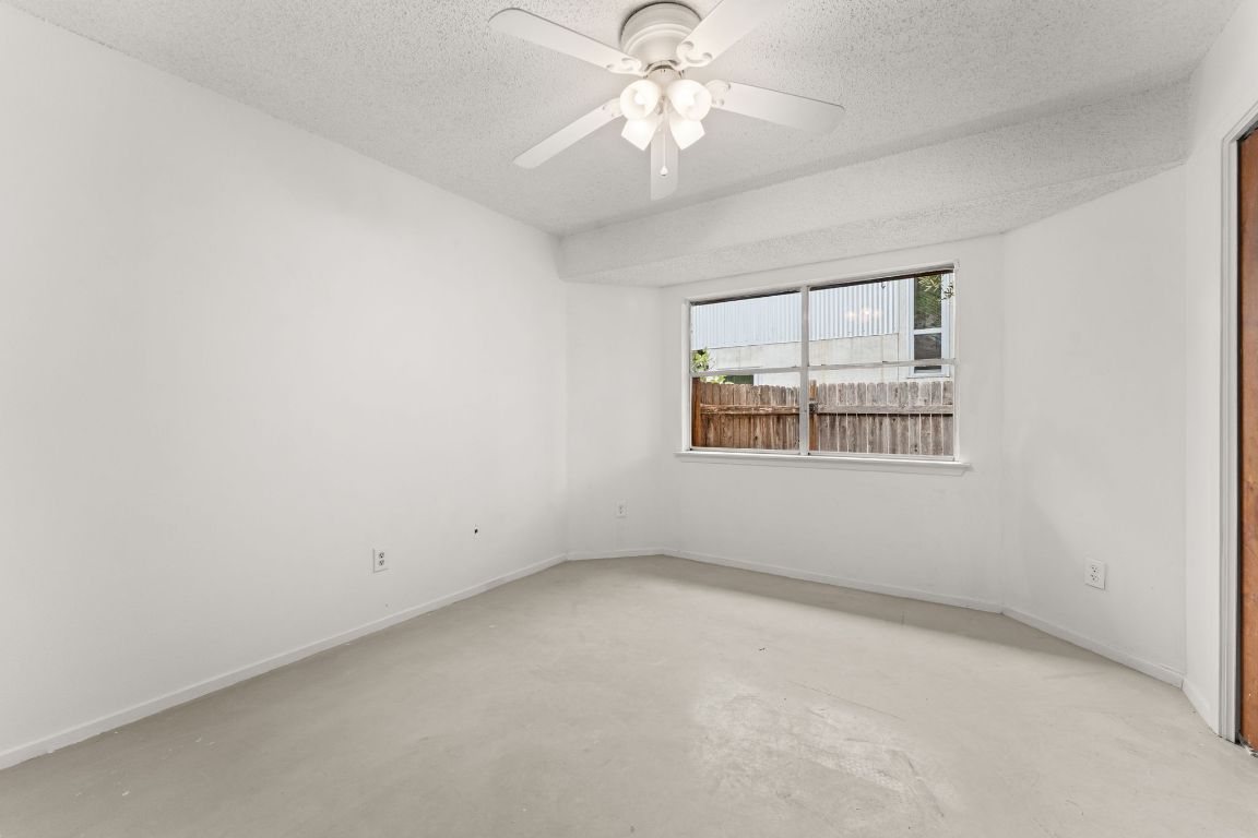 5413 Duval Street Austin, TX 78751 - Photo 18 of 27 an empty room with a window and a ceiling fan