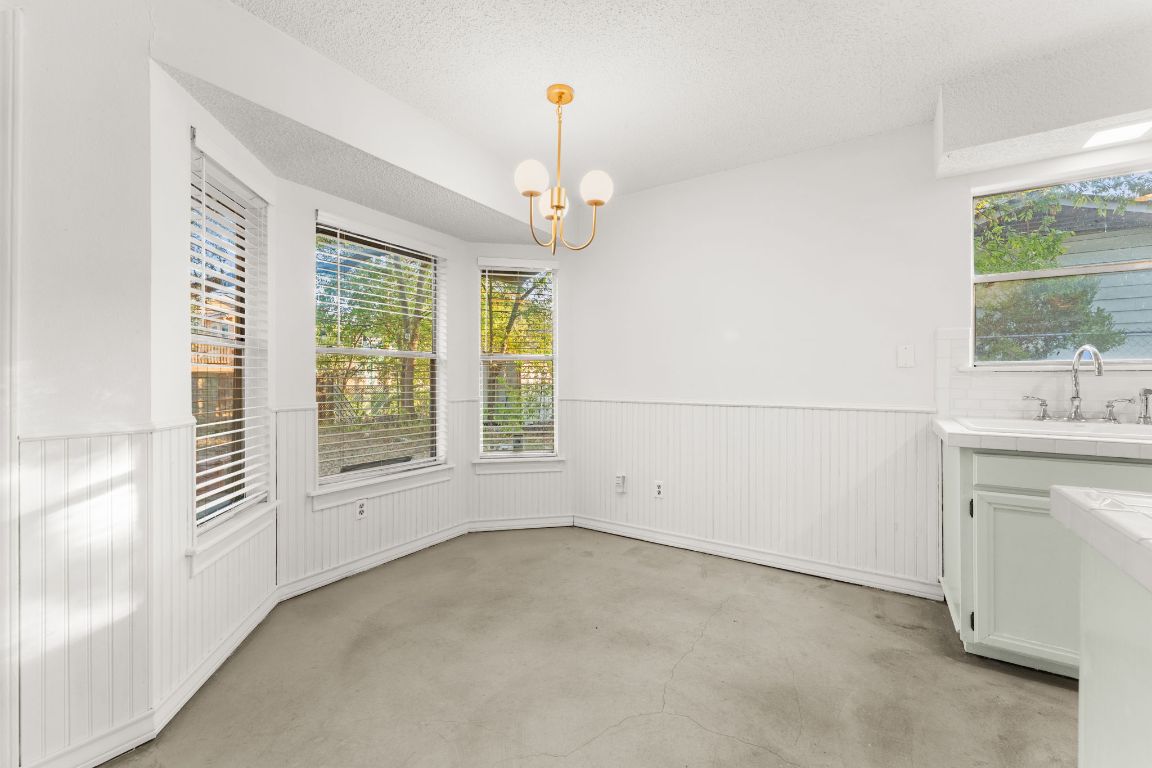 5413 Duval Street Austin, TX 78751 - Photo 19 of 27 an empty room with a windows and chandelier