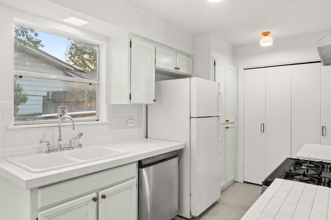5413 Duval Street Austin, TX 78751 - Photo 21 of 27 a kitchen with a sink appliances and cabinets