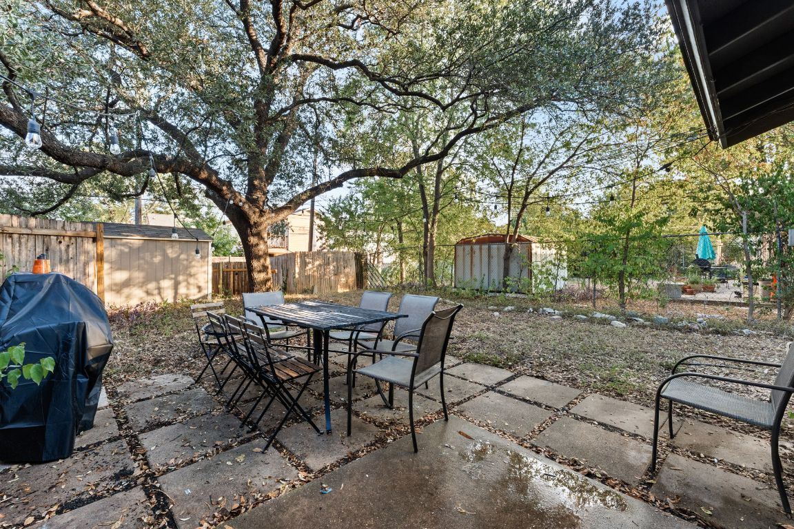 5413 Duval Street Austin, TX 78751 - Photo 24 of 27 a view of a backyard with table and chairs and a barbeque with wooden fence and plants