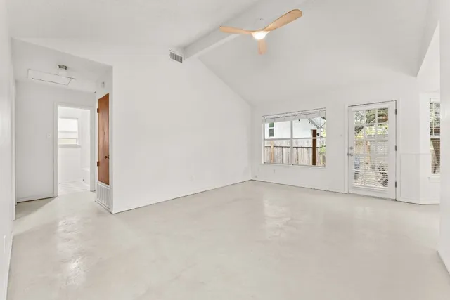 an empty room with windows and closet