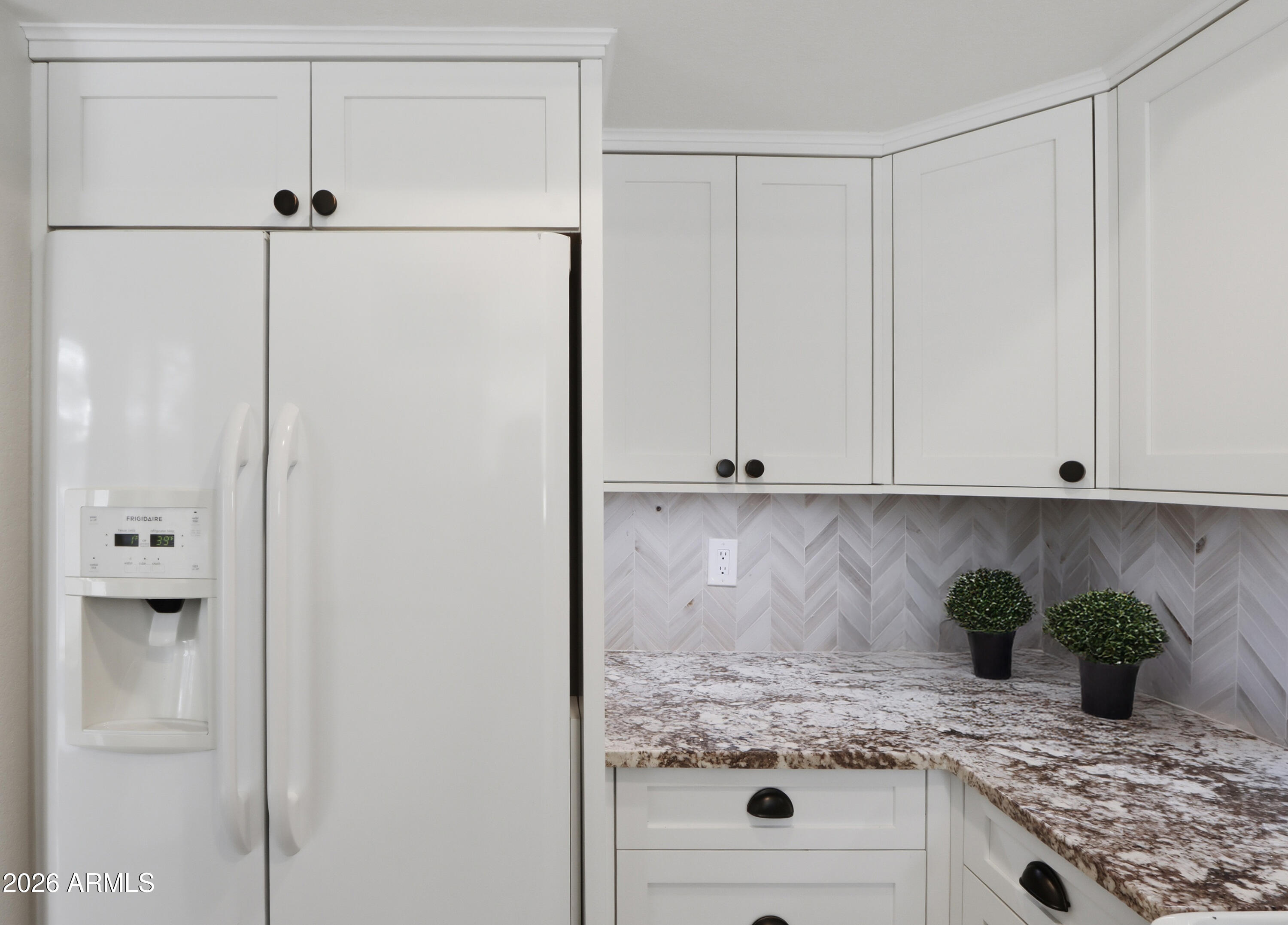 1402 East Osborn Road, Unit 2 Phoenix, AZ 85014 - Photo 10 of 29 a kitchen with a refrigerator and white cabinets