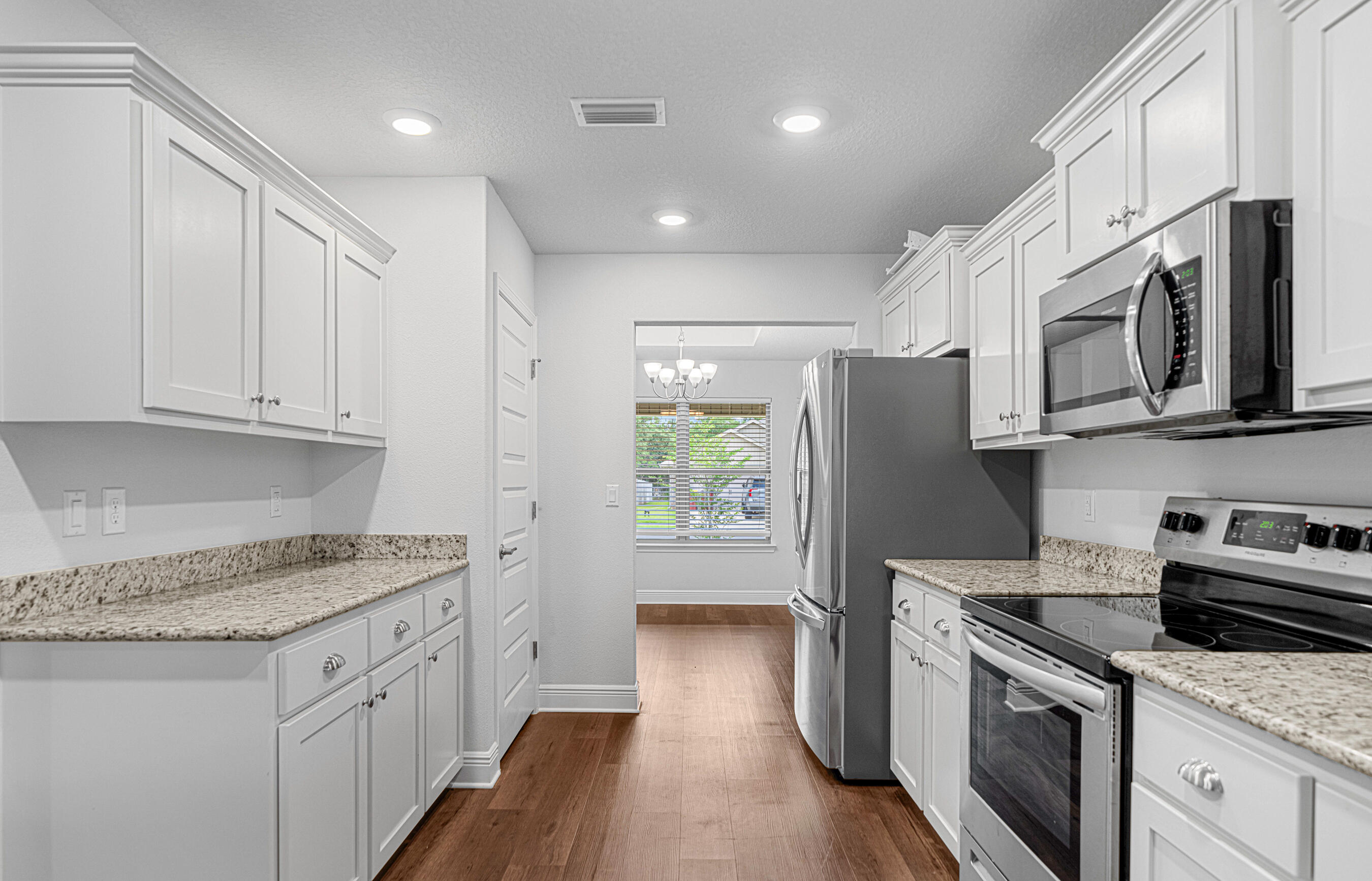 103 Ridgeway Circle Crestview, FL 32536 - Photo 11 of 33 a kitchen with stainless steel appliances granite countertop a refrigerator sink and stove