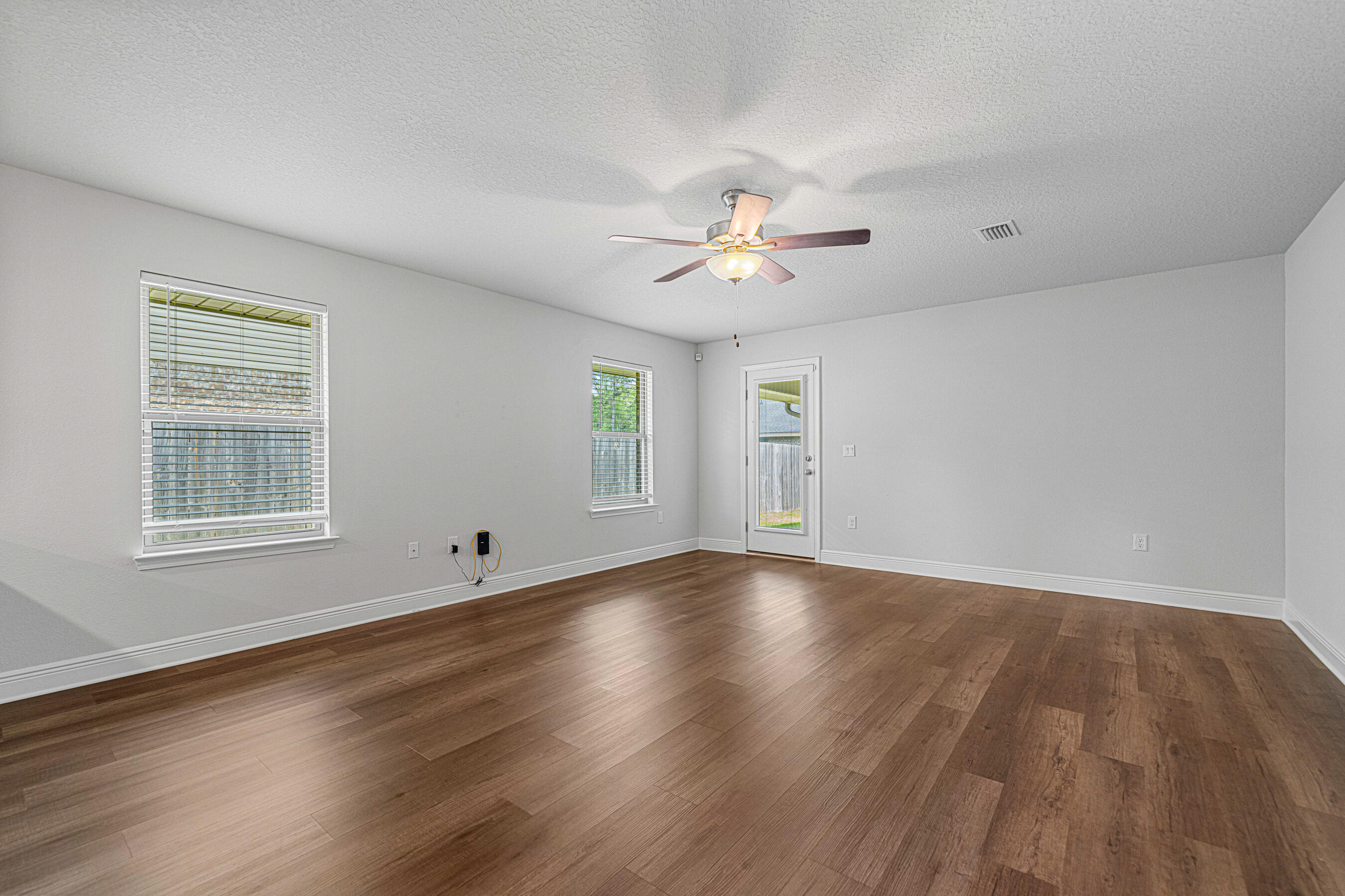 103 Ridgeway Circle Crestview, FL 32536 - Photo 13 of 33 an empty room with wooden floor and window